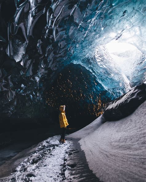 Photographer Captures Incredible Amber Glow Inside Icelands Ice Caves