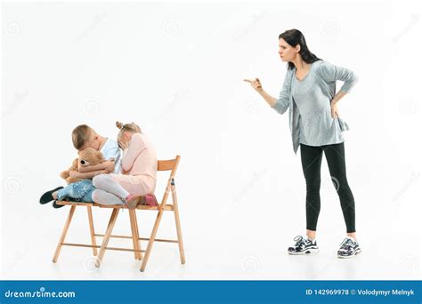 Angry Mother Scolding Her Son In Living Room At Home Stock Photo