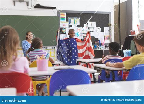 Schoolboy Holding An American Flag In Classroom Stock Image Image Of