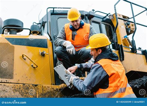 Worker with Heavy Excavation Machinery in Mining Operation Stock Image