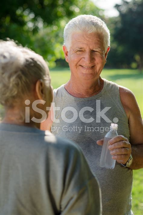 Seniors Drinking Water After Fitness In Park Stock Photo Royalty Free