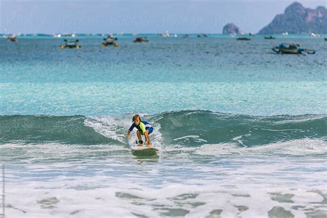 Little Boy Surfing Small Waves In Indonesia By Stocksy Contributor
