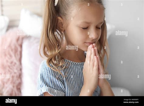 Cute Little Girl Praying In Bedroom Stock Photo Alamy