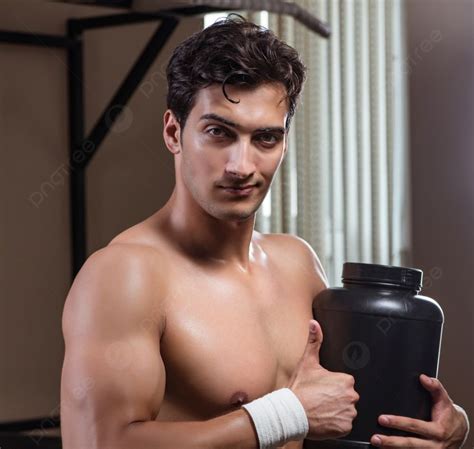The Man With Nutrient Supplements In Sports Gym Man With Nutrient Supplements In Sports Gym