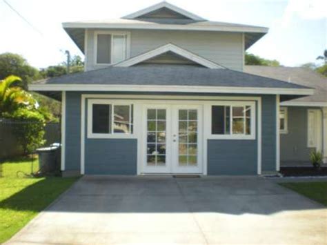 This garage conversion blends a home office and a small seating area complete with a couch for guests. convert exterior garage door with windows | and affordable ...