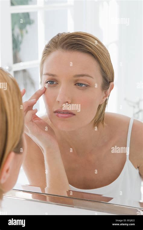 A Woman Touching Her Face Stock Photo Alamy