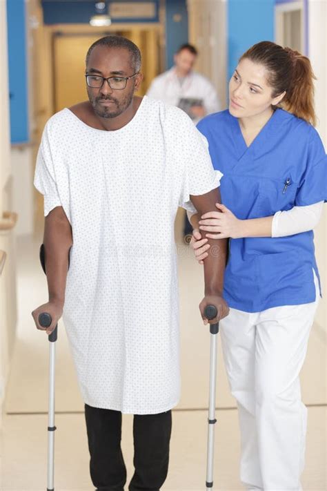 Woman Helping Man With Crutches Stock Image Image Of Health Nurse