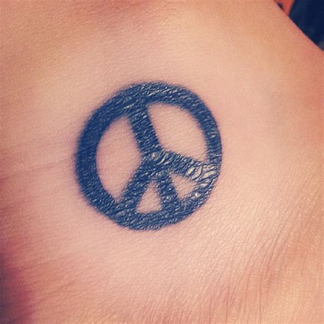 Blue Ink Peace Symbol Tattoo On Ankle