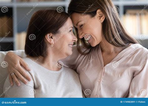 Happy Grown Up Daughter Touching Foreheads With Mother Stock Image