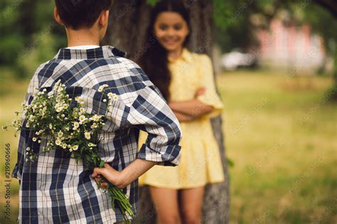 Young Boy Giving Flowers To Girl Sweet Little Boy Holding Bouqet Of