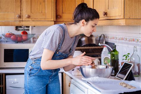 Woman Cooking At Home By Stocksy Contributor Luis Velasco Stocksy