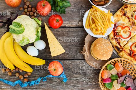 Find images of healthy food. Fastfood And Healthy Food On Old Wooden Background Concept ...