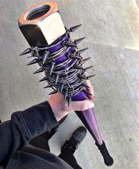 A Person Holding A Purple Object With Spikes On It