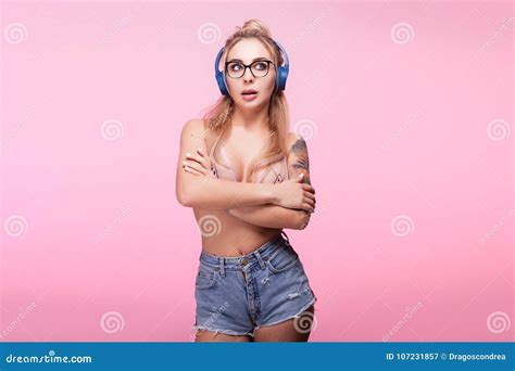 Hot Blonde Woman With Headphones On Listening To Music Stock Image
