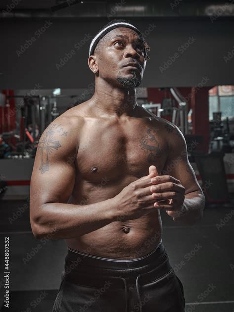 Sports African American Guy With Naked Muscular Torso Posing In Gym
