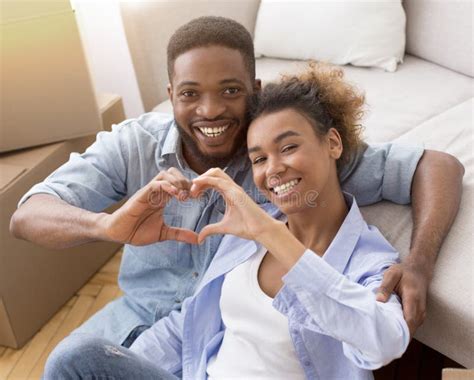 Black Couple Holding Remote Control And Debit Credit Card Stock Image