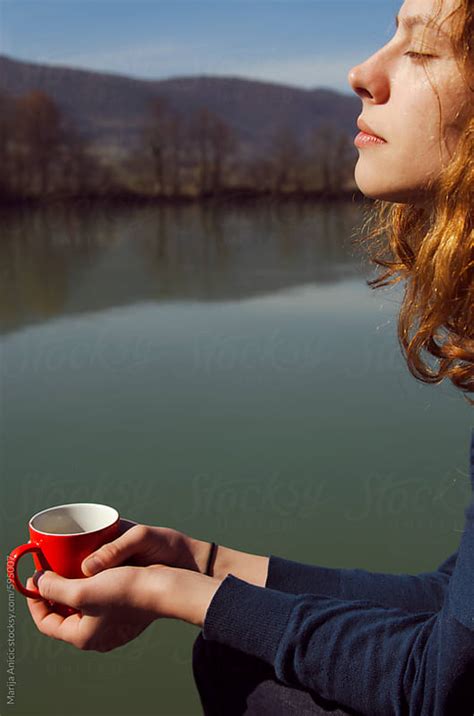 Redhead Girl Enjoying Drinking Coffee On The Sun By Marija Anicic