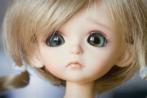A Doll With Blonde Hair And Blue Eyes