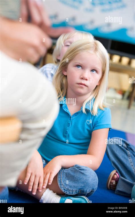 Student In Class Sitting On Floor Looking At Teacher Selective Focus