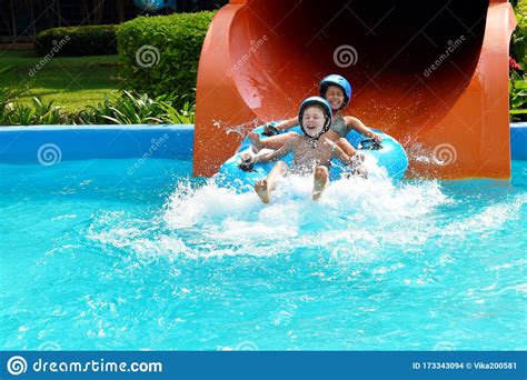 Children In The Outdoor Pool Funny Kids At The Water Park Happy