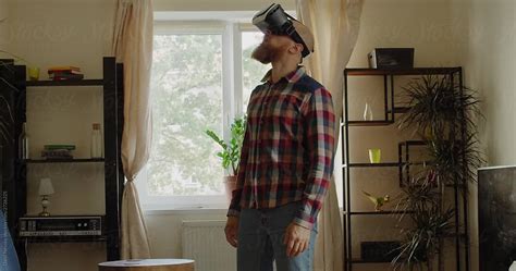 Serious Adult Male Gamer Playing Game In Vr Glasses At Home By