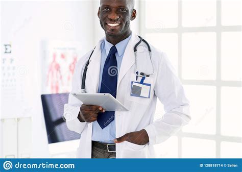 Male Black Doctor Worker With Tablet Computer Standing In Hospital ...