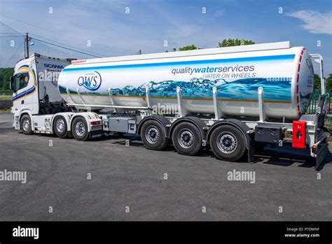 fresh water tanker towed by a Scania truck filling up with water Stock