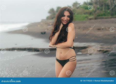 Portrait Of Tanned Smiling Girl With Closed Eyes In Swimsuit Resting On