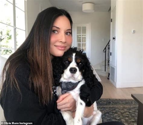 Olivia Munn Shows Off Her Long Tan Legs As She Cuddles Up To Her Dog
