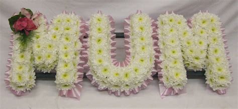 Funeral sheaves fashioned out of cut flowers including red, purple, white, yellow chrysanthemums: RJ's Florist: 10/10