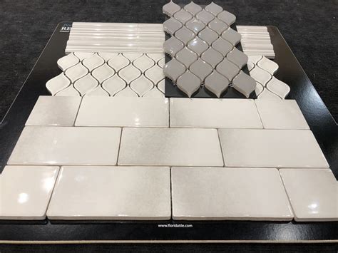 A Black Table Topped With White Tiles On Top Of It