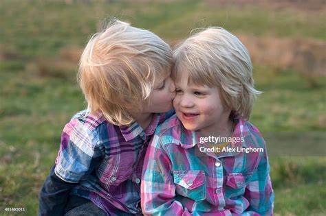 Identical Twin Boys One Kissing The Other High Res Stock Photo Getty