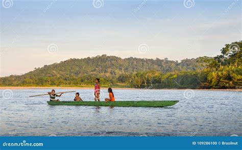 Local Quechua Tribe Teenagers In The Ecuadorian Amazon On A Canoe On