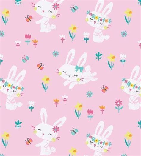 a pink background with white rabbits and flowers