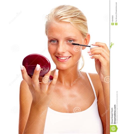 Lovely Woman Applying Mascara Against White Stock Image