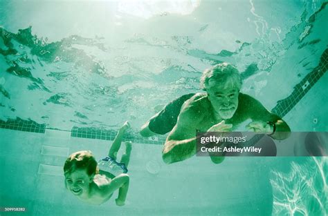 Grandpa And Grandson Swimming Together Underwater In Summer High Res