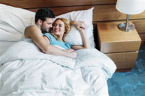 Boyfriend Hugging Girlfriend In Bed In Morning Stock Photo Dissolve