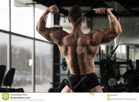 Muscular Man Flexing Back Muscles Pose Stock Photo Image Of Indoors