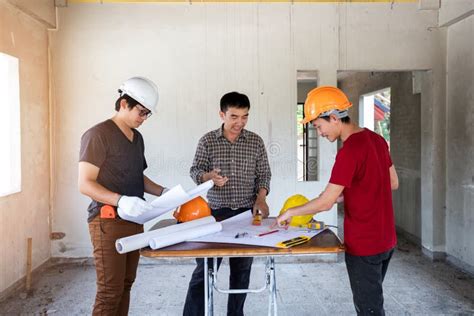 Engineer And Architect Discussing With Foreman About Project In