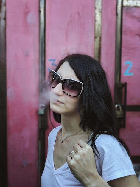 Premium Photo Woman Wearing Sunglasses Smoking Outdoors