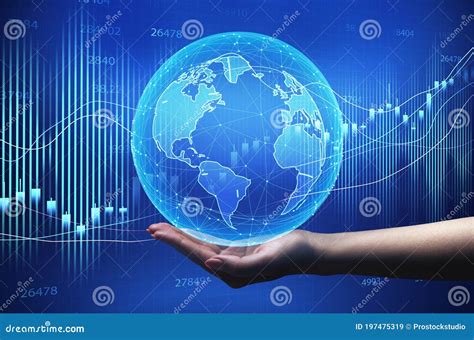 Hand Holding Globe Over Blue Background With Global Economy Graphs