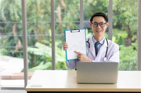 Male Doctor Holding Medical Clipboard Paper Empty Space For Writing