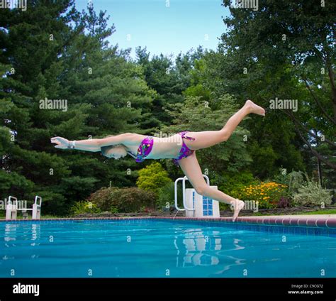 Young Girl Diving Into A Swimming Pool Stock Photo Alamy