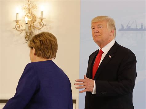 trump and merkel pose for awkward photos handshake before g20 summit business insider