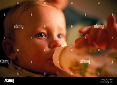 Baby Girl Drinking Milk From Bottle Stock Photo Alamy