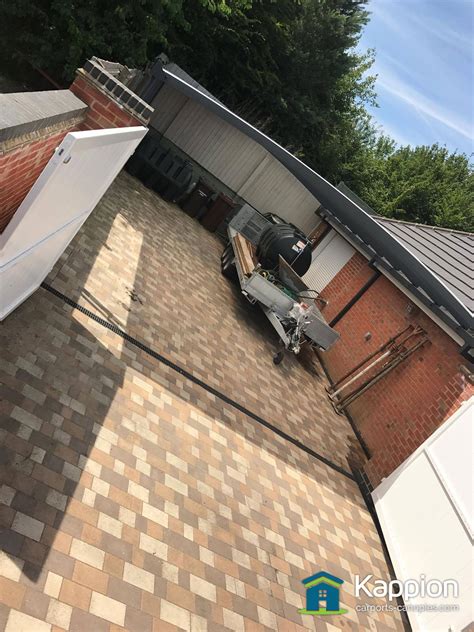 Delivery and installation are included. Garage Attached Double Carport/Work Area Installed in Suffolk | Kappion Carports & Canopies
