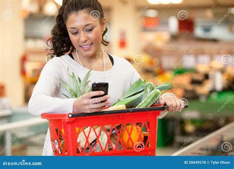 Smiling Woman Using Mobile Phone In Shopping Store Stock Photo Image