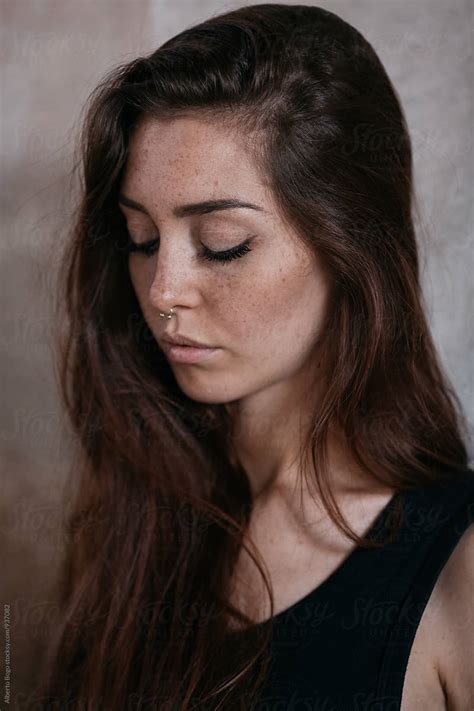 Close Up Of Freckled Woman With Eyes Closed By Alberto Bogo