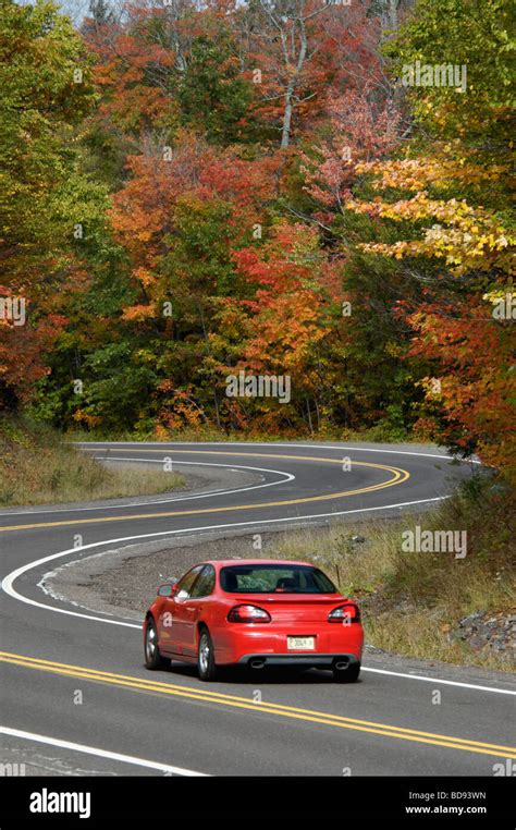 Car Driving Down Winding Road Through Autumn Forest In The Keweenaw