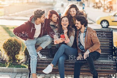 Group Of Friends Laughing At A Message Stock Photo